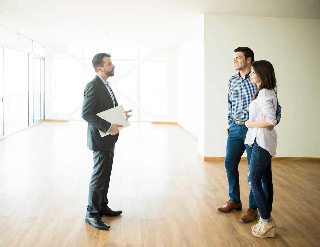 couple-with-real-estate-agent-visiting-new-house-2026-01-05-00-05-15-utc 1